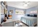 Bright bedroom featuring a striped bedspread and a ceiling fan at 8677 Sw 95Th Ln # F, Ocala, FL 34481