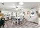 Well-lit dining room with white table and chairs, and wood-look floors at 8677 Sw 95Th Ln # F, Ocala, FL 34481