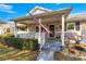 Home exterior featuring a porch, landscaping, and American flag at 8677 Sw 95Th Ln # F, Ocala, FL 34481