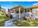 Charming front porch with rocking chairs and American flag at 8677 Sw 95Th Ln # F, Ocala, FL 34481