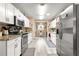 Bright kitchen with white cabinets, stainless steel appliances, and a tile backsplash at 8677 Sw 95Th Ln # F, Ocala, FL 34481