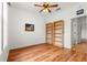 Bedroom with wood floors, built-in shelves and ceiling fan at 8796 Sw 83Rd Cir, Ocala, FL 34481