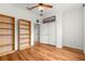 Bedroom with wood floors, built-in shelves, and large closet at 8796 Sw 83Rd Cir, Ocala, FL 34481