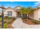 Landscaped front yard with palm trees and brick walkway at 8796 Sw 83Rd Cir, Ocala, FL 34481