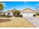 Two-car garage and front yard with landscaping at 8796 Sw 83Rd Cir, Ocala, FL 34481