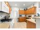 Modern kitchen with wood cabinets, granite countertops, and stainless steel appliances at 8796 Sw 83Rd Cir, Ocala, FL 34481