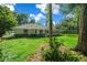 Large backyard with lush lawn and mature trees at 8930 Sw 8Th St, Ocala, FL 34481