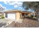 House exterior showcasing a front porch and attached garage at 9111 Sw 102Nd Cir, Ocala, FL 34481