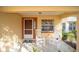 Front porch with two rocking chairs and a small side table at 9111 Sw 102Nd Cir, Ocala, FL 34481