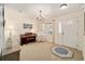 Living room with carpeted floor, chandelier, and access to the entryway at 9111 Sw 102Nd Cir, Ocala, FL 34481