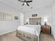 Charming bedroom with a queen-size bed, nightstands, and hardwood floors at 9270 Sw 9Th Ter, Ocala, FL 34476