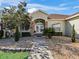 Front entry of a single-story home with stone accents and walkway at 9270 Sw 9Th Ter, Ocala, FL 34476