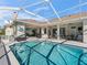 Large screened-in pool with patio seating at 9270 Sw 9Th Ter, Ocala, FL 34476