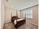 Bedroom with wooden four-poster bed and window with blinds at 9326 Sw 52Nd Loop, Ocala, FL 34481