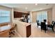 Modern kitchen with dark brown cabinets, stainless steel appliances and breakfast bar at 9326 Sw 52Nd Loop, Ocala, FL 34481