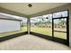 Screened-in porch with view of homes and grassy backyard at 9326 Sw 52Nd Loop, Ocala, FL 34481