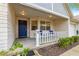 Inviting front porch with blue door and white railing at 9662 Sw 95Th Ct # A, Ocala, FL 34481