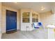 Covered entry with blue door and two blue chairs at 9662 Sw 95Th Ct # A, Ocala, FL 34481