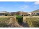 Backyard view of home with landscaping and a screened patio at 9840 Sw 90Th St, Ocala, FL 34481