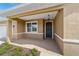 Covered porch with dark front door and sidelights at 9840 Sw 90Th St, Ocala, FL 34481