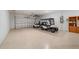 Garage with golf cart, storage, and overhead storage at 9840 Sw 90Th St, Ocala, FL 34481