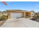 Tan one-story house with a two-car garage and American flag at 9840 Sw 90Th St, Ocala, FL 34481