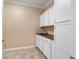 Laundry room with white cabinets and butcher block countertop at 9840 Sw 90Th St, Ocala, FL 34481