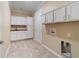 Bright laundry room with white cabinets and a utility sink at 9840 Sw 90Th St, Ocala, FL 34481