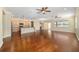 Open living room with hardwood floors, ceiling fans, and views of the kitchen at 9840 Sw 90Th St, Ocala, FL 34481