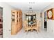 Charming dining room featuring a glass-top table and wooden hutch at 9981 Sw 101St Pl, Ocala, FL 34481