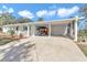 Front view of a house with carport and golf cart at 9981 Sw 101St Pl, Ocala, FL 34481