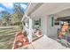 Front porch with white railing and landscaping at 9981 Sw 101St Pl, Ocala, FL 34481