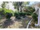 Landscaped backyard with mature shrubs and trees at 10602 Se 179Th Ln, Summerfield, FL 34491