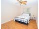 Cozy bedroom with wood floors and ceiling fan at 10602 Se 179Th Ln, Summerfield, FL 34491