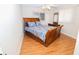 Cozy bedroom featuring a wooden sleigh bed and hardwood floors at 10602 Se 179Th Ln, Summerfield, FL 34491