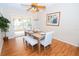 Dining room features a wooden table with blue striped chairs and access to a patio at 10602 Se 179Th Ln, Summerfield, FL 34491