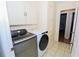 Laundry room with washer, dryer, and additional storage at 10602 Se 179Th Ln, Summerfield, FL 34491