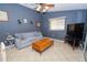 Bright living room with comfy sofa and large TV at 10602 Se 179Th Ln, Summerfield, FL 34491