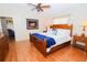 Main bedroom with wood floors and ensuite bathroom at 10602 Se 179Th Ln, Summerfield, FL 34491