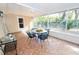 Outdoor screened patio with table and chairs, perfect for dining at 10602 Se 179Th Ln, Summerfield, FL 34491