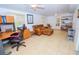 Sunroom with tiled floor, leather couch, and a workspace at 10602 Se 179Th Ln, Summerfield, FL 34491