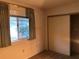 Bedroom with window, closet, and light brown carpet at 10968 Sw 80Th Ct, Ocala, FL 34481