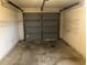 Garage with overhead door and storage shelves at 10968 Sw 80Th Ct, Ocala, FL 34481