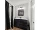 Modern bathroom with dark wood vanity, stylish mirror, and walk-in shower with glass door at 11 Bahia Court Loop, Ocala, FL 34472
