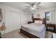 Cozy bedroom with ceiling fan, two closets, and a wood bed frame on carpet at 11 Bahia Court Loop, Ocala, FL 34472
