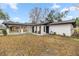 White single story house with a carport and landscaping at 11 Bahia Court Loop, Ocala, FL 34472