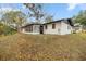 The back of the home shows a sunroom, a black door and neutral colors at 11 Bahia Court Loop, Ocala, FL 34472