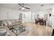 Open-concept living room with wood floors, neutral decor, and plenty of natural light at 11 Bahia Court Loop, Ocala, FL 34472