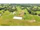 Aerial view of property with home, pool, and riding arena at 12000 S Highway 475, Ocala, FL 34480