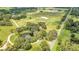 Aerial view of expansive estate with equestrian facilities and lush landscaping at 12000 S Highway 475, Ocala, FL 34480